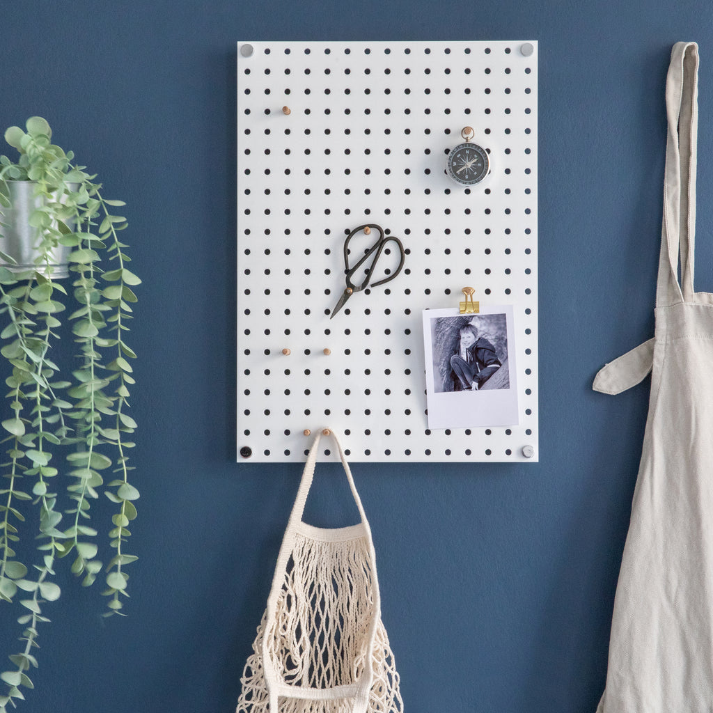 White Pegboard With Wooden Pegs
