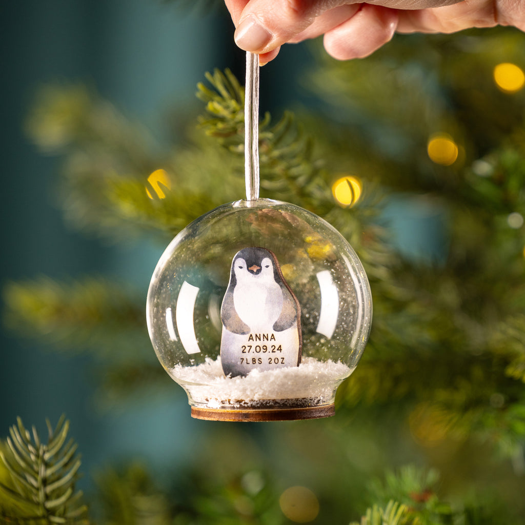 Personalised Illustrated Penguin First Christmas Snow Bauble